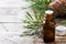 Cedar and spruce essential oil in small glass bottles on wooden background. Selective focus.