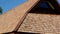 The cedar wooden shingle rooftop of the small log house