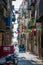 Cefalu old town narrow street view with cars parked and small balconies at the morning