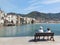 Cefalu, Sicily, Italy. May 10, 2017. A couple siting in the harbor of Cefalu