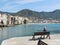 Cefalu, Sicily, Italy. May 10, 2017. An old woman siting in the harbor in Cefalu