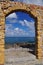 Cefalu, Sicily, Italy. Stone arch gate, Mediterranean sea view