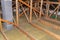 Ceiling and attic floor insulation made of rock wool between the trusses, visible system chimney.