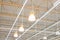 Ceiling with bright lamps in a modern warehouse. Image of bright light, a large space for trade, storage, commercial activity