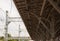 The ceiling design of an open railway station on the background of high-voltage wires. Canopy over the railway station made of