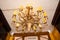 Ceiling golden color luxury retro chandelier luster. View from below. St Petersburg, Russia - 05.29.2022