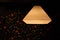 Ceiling lamp shade glowing over background.