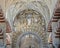 Ceiling and Muslim arch with Christian reliefs in the Hypostyle Prayer Hall of the Mosque-Cathedral of Cordoba in Spain.