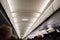 ceiling in passage between seats in cabin of aircraft. flying during pandemic.