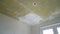 Ceiling repair before plastering. White ceiling in the kitchen. The ceiling is primed, repair in the apartment.