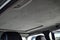 The ceiling of the SUV car with sunroof pulled by gray soft material in the workshop for tuning and styling the interior of the