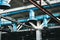 The ceiling in the workshop at the industrial chemical petrochemical machine-building refinery with blue metal iron large pipes