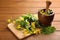 Celandine with board, mortar and pestle on wooden table