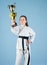 Celebrate achievement. Karate gives feeling of confidence. Strong and confident kid. Girl little child in white kimono
