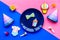 Celebrate child`s birthday. Cookies in shape of baby accesssories, party hats, gift box, confetti on pink and blue