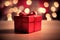 Celebrate gift box on the table with defocused bokeh light background. New year event and Christmas celebration concept.