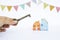 Celebrate new house concept, vintage style key with house model and pennant flag on white background