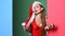 Celebrate pool party. Santa girl with make up. Girl red swimsuit and santa hat hold christmas ball decoration