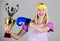 Celebrate victory. Boxing champion. Athletic girl boxing glove and golden goblet. Woman wear sport outfit. Girl cheerful