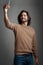 Celebrate yourself with a selfie. Studio shot of a handsome young man taking a selfie on his cellphone against a gray