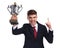 Celebrating businessman holding trophy and pointing finger up