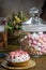 Celebrating marshmallow, cupcake on wooden table, flowers birthday party