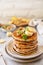 Celebrating Pancake day, american homemade breakfast. Banana gluten free pancakes with nuts and caramel on stone tabletop. Copy