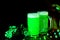 Celebrating Saint Patrick Day. Mugs of green beer, leaves of shamrock on the black backgroun with lights and bokeh. National irish