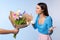 Celebrating Special Occasion. Giving girl a bouquet of colorful wilted tulips. Man greeting lady with international