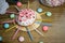 Celebrating sweet cupcake, candles on wooden table, candies birthday party