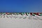 Celebrating the UAE State Flag Day. On the clean white sand of the beach, an installation of many flags