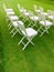 Celebration arrangment of the white wooden chairs on the grass