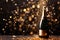 A celebration bottle of champagne with gold sparkling glitter confetti