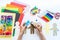 Celebration of bringing people together from all over the world Child makes a paper craft hands. Rainbow Flag Day