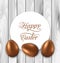 Celebration card with Easter chocolate eggs on wooden grey background