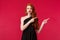 Celebration, events, fashion concept. Portrait of uneasy and sad pretty redhead woman in black dress, grimacing and