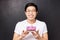 Celebration, holiday and birthday concept. Close-up portrait of happy, cheerful b-day guy holding cake with lit candle