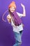 Celebration Ideas. One Expressive Winsome Caucasian Girl in Coral Winter Warm Hat and Violet Knitted Scarf Having Fun With Vivid