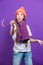 Celebration Ideas. One Expressive Winsome Caucasian Girl in Coral Winter Warm Hat and Violet Knitted Scarf Having Fun With Vivid