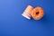 Celebration of the King`s Day in the Netherlands. Fun holidays. Orange cups and sweet donuts on a blue background. Free space for