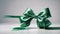 A celebratory bow fashioned from green satin ribbon.