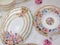 Celebratory china. decorated with flowers. Soft colors. Luxurious dining table for gourmet dinners at festive or formal occasions