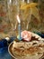 Celebratory table (piece of birthday cake and blue candle, two g