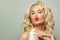 Celebrity beauty woman blowing kiss on white, fashion portrait. Red lips makeup and black eyeliner arrow on eyes