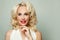 Celebrity beauty woman with red lips makeup and blonde curly hair smiling on white, fashion portrait