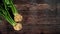 Celeriac turnip rooted celery roots with green leaves on dark wooden rustic board, photo from above - wide banner with space for