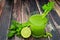 Celery juice in a glass over a rustic dark wood background