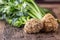 Celery root. Fresh celery root with leaf on rustic oak table