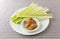 Celery stalks with peanut butter on a white plate