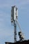 Cell antenna on a roof against blue sky background